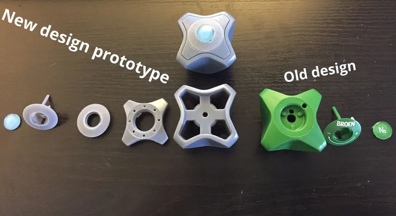 Photo of 3D-printed prototypes of the new handle next to the old green handle