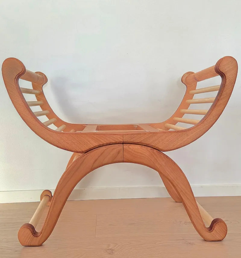 Photo of the Mona chair frame in oak against a white wall