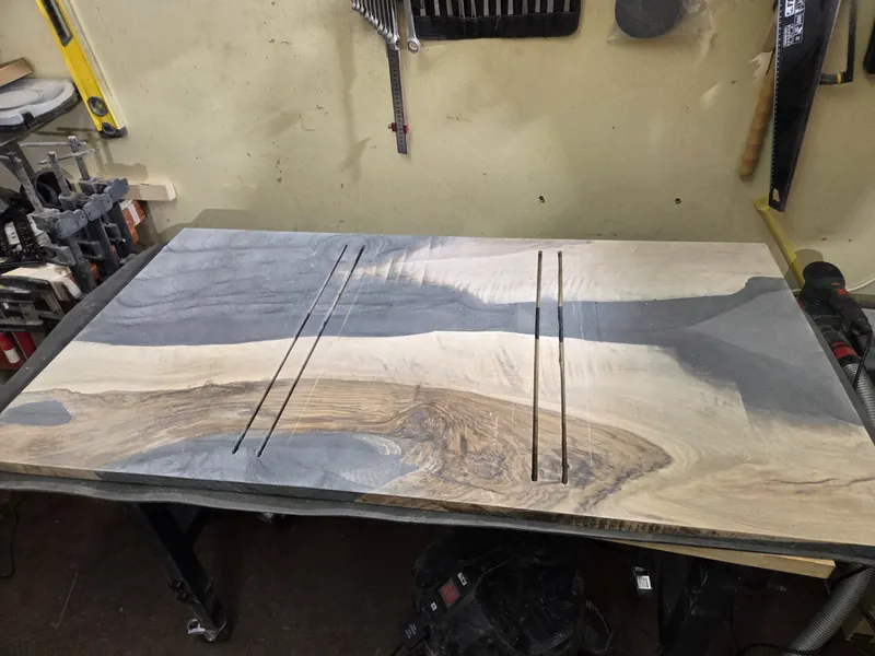The cast table top lying in the mould in the workshop