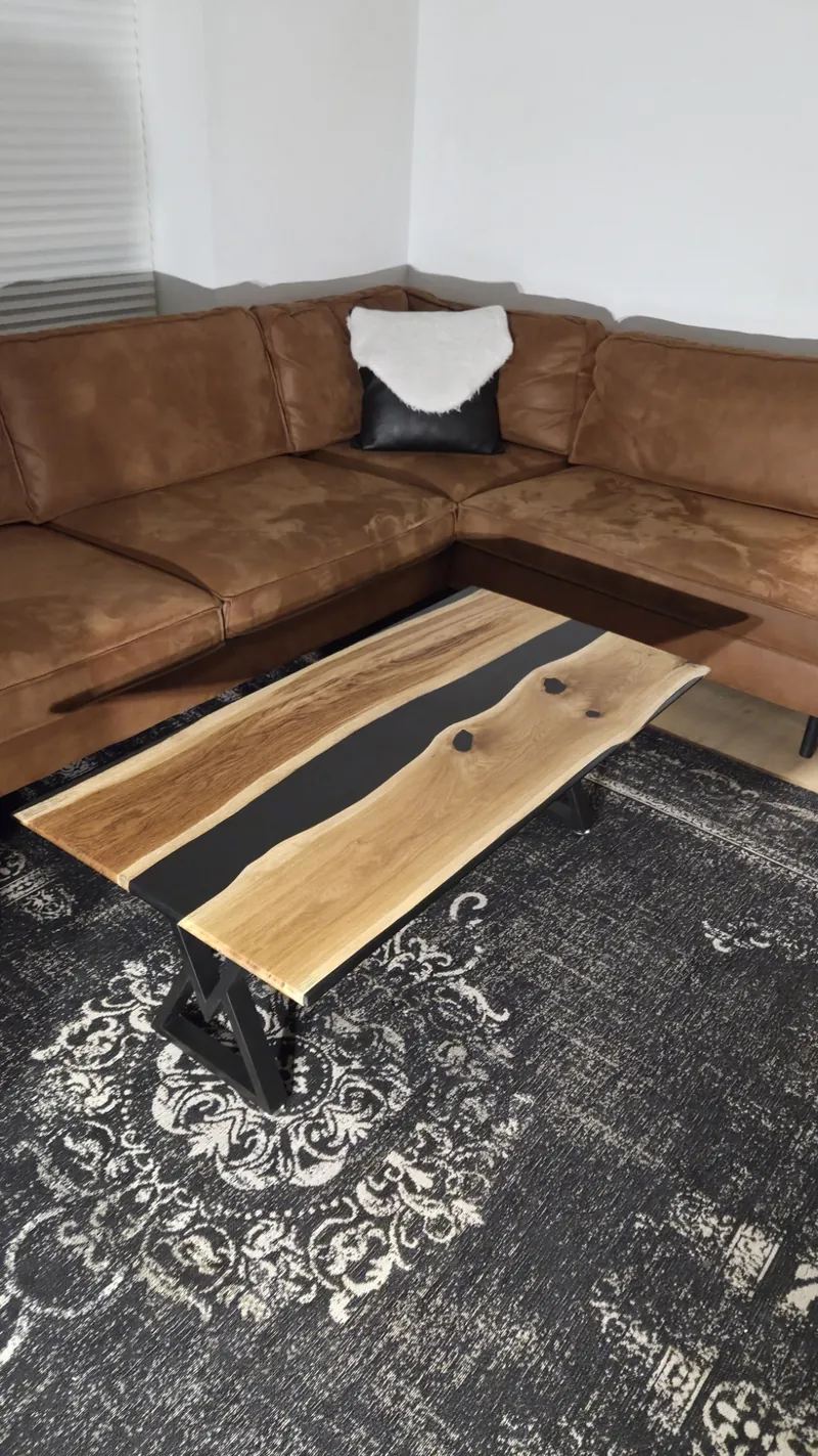 Photo of the Strøm coffee table in a living room in front of a leather sofa